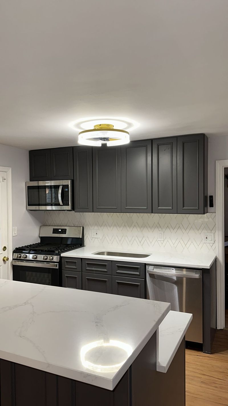 Charcoal shaker kitchen with island and gold hardware