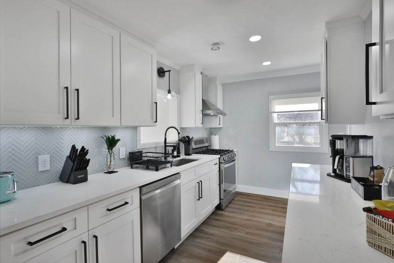 Refined white kitchen with contrasting island and gold hardware