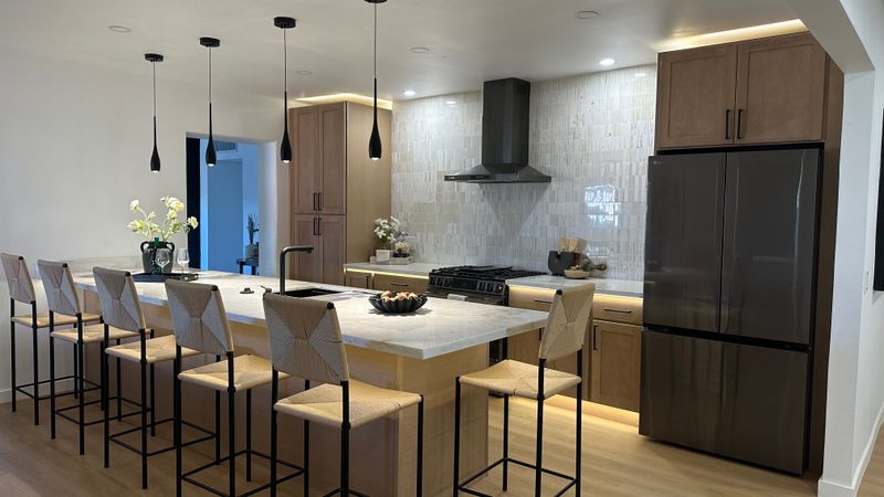 Finished kitchen with custom cabinetry and a spacious island.