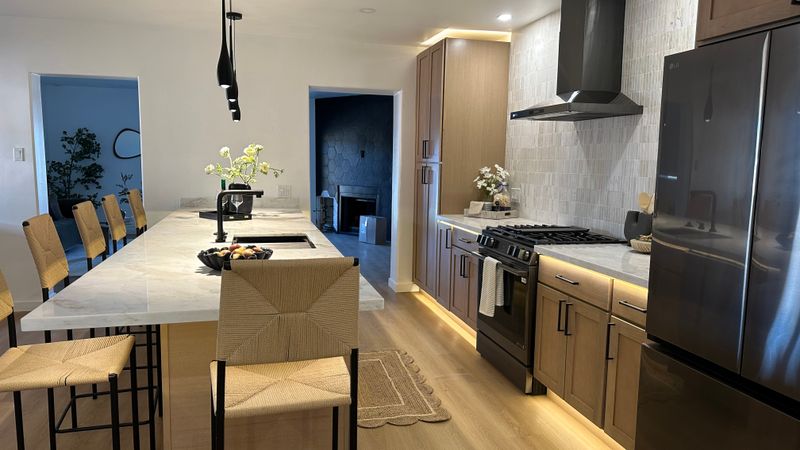 Kitchen sink detail with large window and continuous backsplash