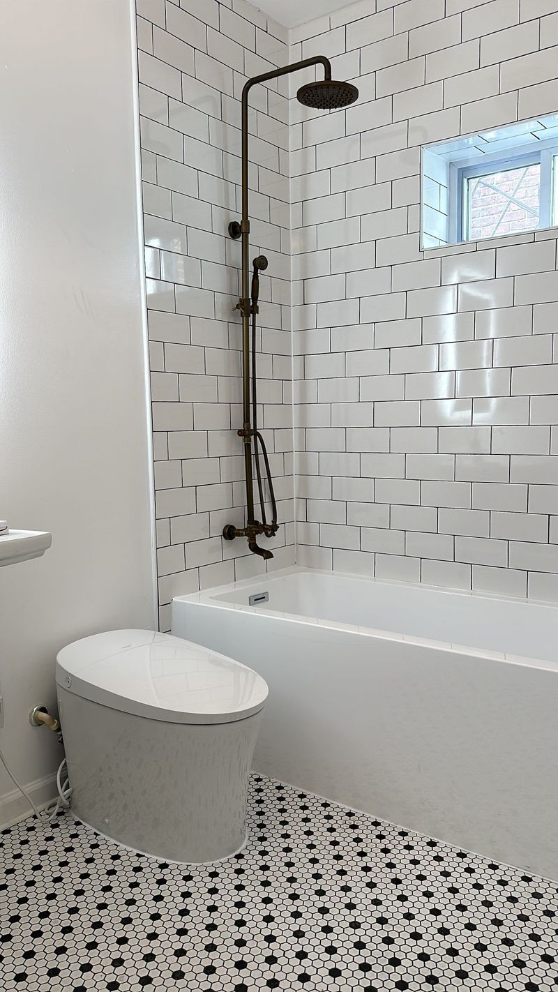 Finished bathroom with coordinated tile, vanity, glass, and fixtures.