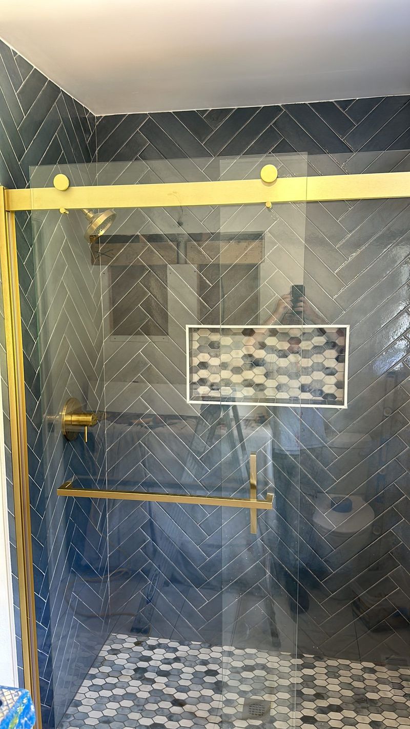 Shower installation in progress with protective tape on the glass
