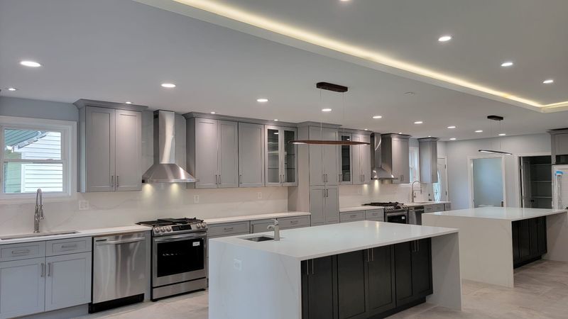 Grey kitchen featuring double islands and extensive custom cabinetry