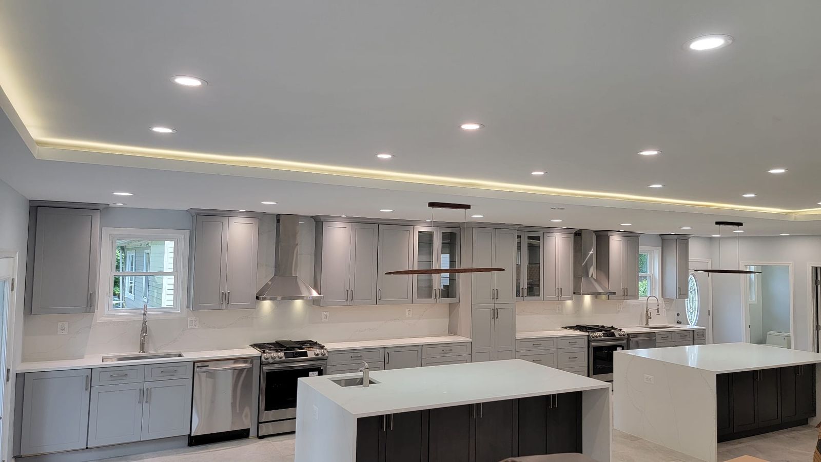 Finished kitchen with two islands and coordinated gray cabinetry