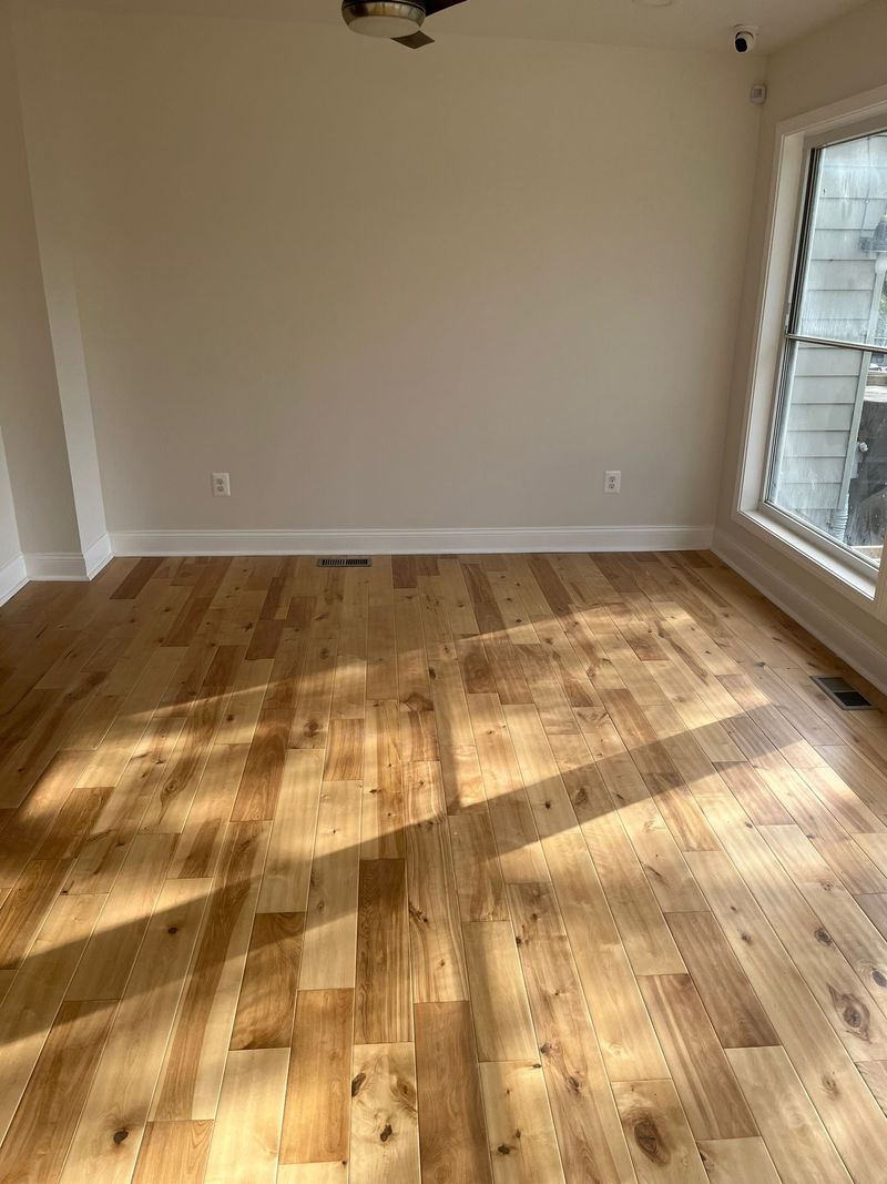 Natural light across finished hardwood flooring