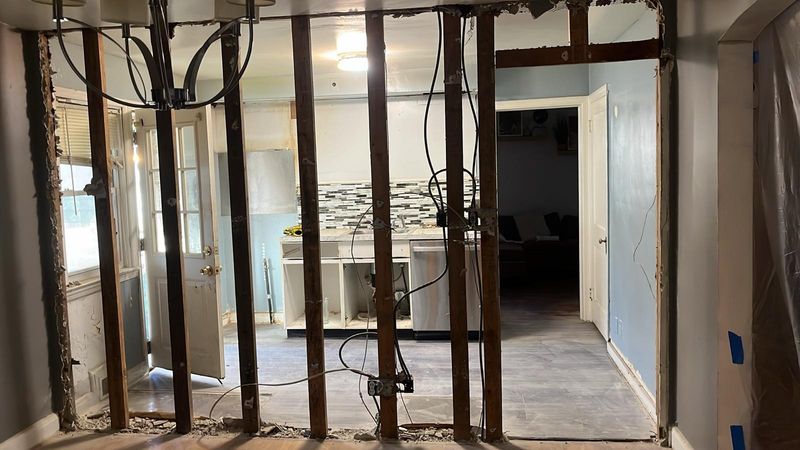 The wall between the kitchen and the living area, opened to the studs
