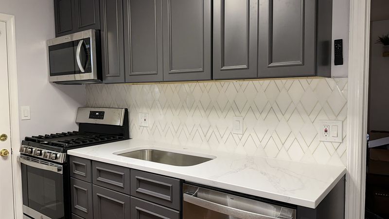 Range wall with gas range, over-the-range microwave and dishwasher