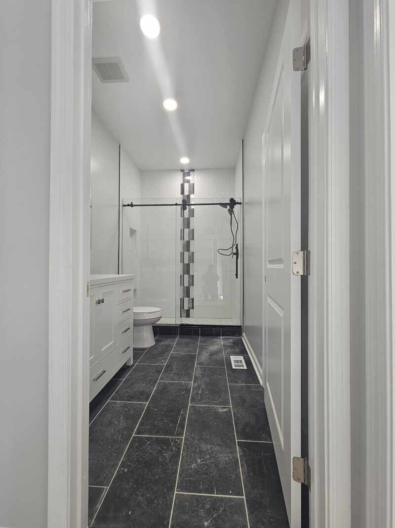 White bathroom shower and coordinated floor tile