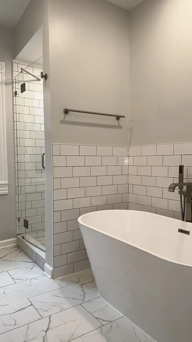 Finished bathroom with a freestanding tub and glass shower