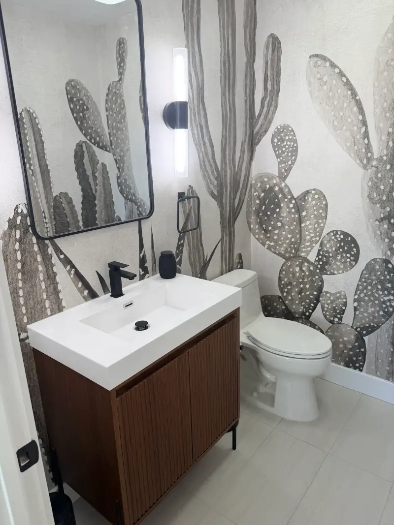 Finished cactus mural powder room with a fluted walnut vanity